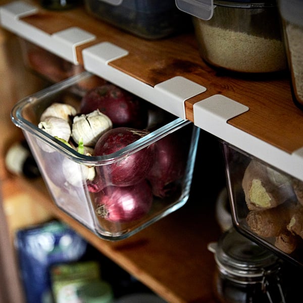 Glass container storing beets and garlic, part of IKEA 365+, organises kitchen items neatly.