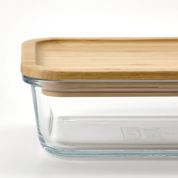 Clear glass food container with natural bamboo lid, showing off its sturdy and stylish design.