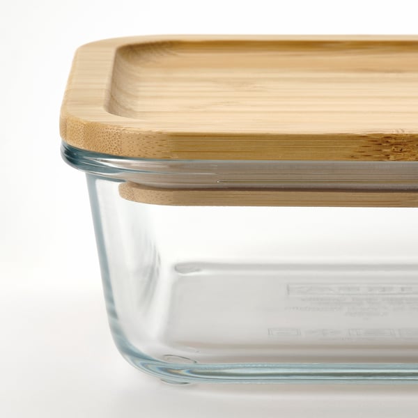 Clear glass food container with snug bamboo lid, ideal for storing and serving meals.