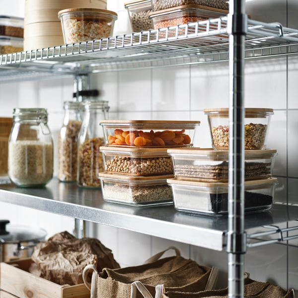 Shelves with IKEA 365+ food containers, holding grains and dried fruits, lids act as coasters.