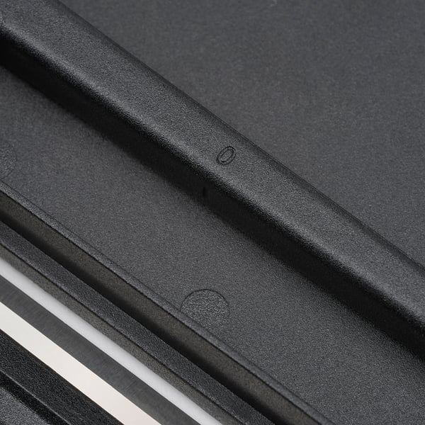 Black plastic utensil holder with rounded edges and dial on the back for adjusting slice thickness.