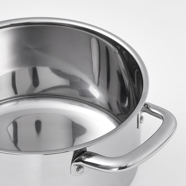 Close-up of stainless steel pots polished, reflective interior showcasing its smooth, rounded edges designed for easy stirring or beating.