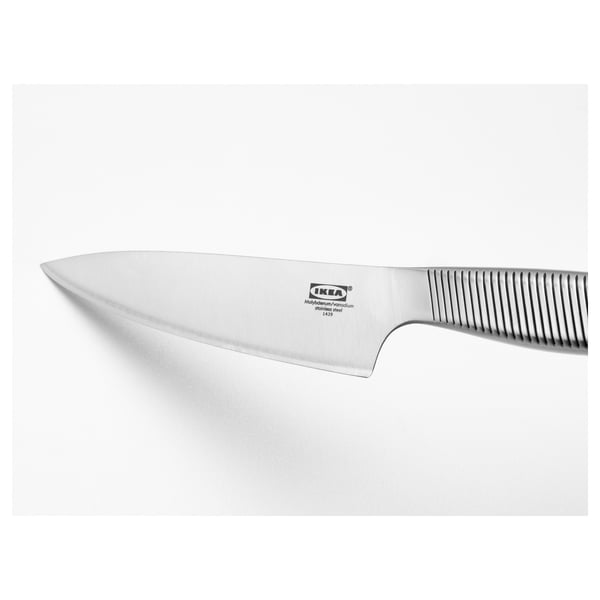 Silver utility knife with serrated edge handle. Ikea branding visible on blade. Designed for durability and sharpness.