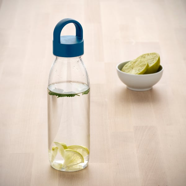 Transparent ikea bottle with blue lid, water, lemon, mint. Small lemon bowl nearby.