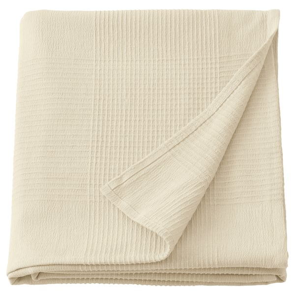 INDIRA: off-white cotton bedspread, folded square, neutral textured design.