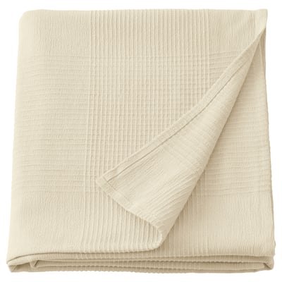 INDIRA: off-white cotton bedspread, folded square, neutral textured design.
