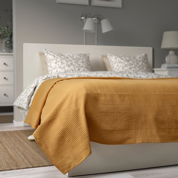 Golden INDIRA bedspread on large bed, intricate cotton texture, comfort & warmth, 100% cotton 50% recycled.