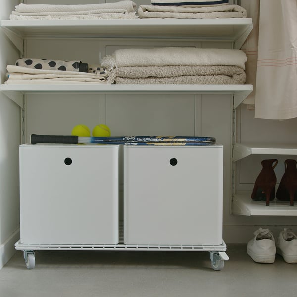 White storage trolley with casters, 2 large boxes, and upper shelf holding towels and sports gear.