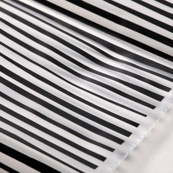 Black and white striped bags, neatly arranged, showcasing their reusable and transparent design for organising and storing items.