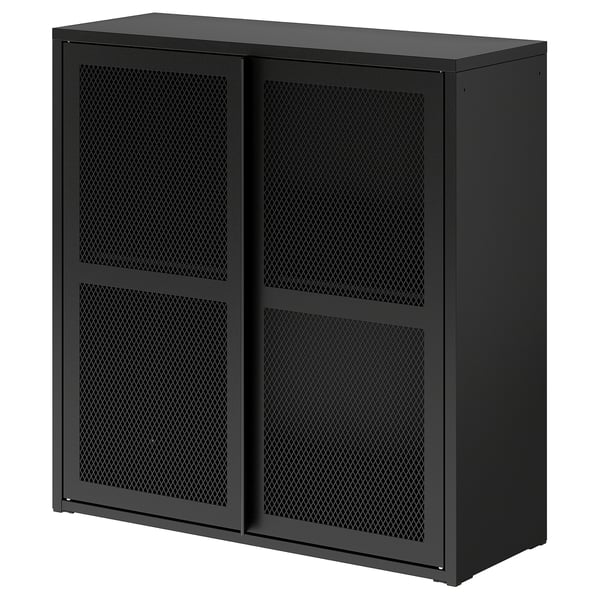 A black IVAR mesh cabinet with a metal grid design, standing on a flat surface. It’s rectangular, featuring two doors and a top shelf.