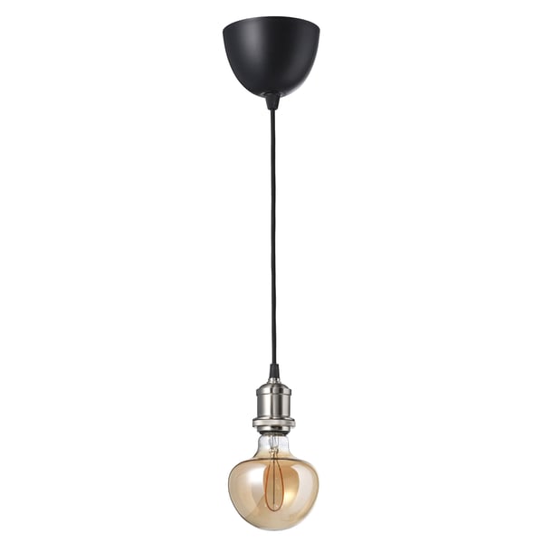A JÄLLBY pendant lamp with a black cord, hanging a bulb with a warm brown glass bulb and a matching filament, emitting a cosy glow.