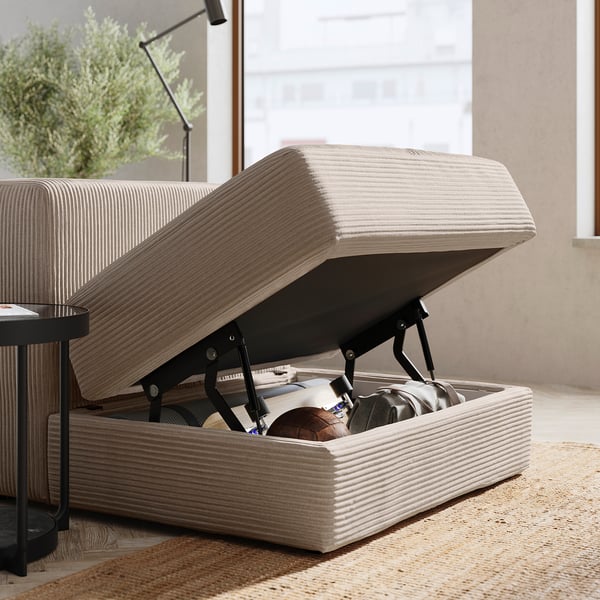 Modern cream-colored sofa with storage. Open lid reveals hidden items. Sleek, rectangular design with a cosy, striped texture.