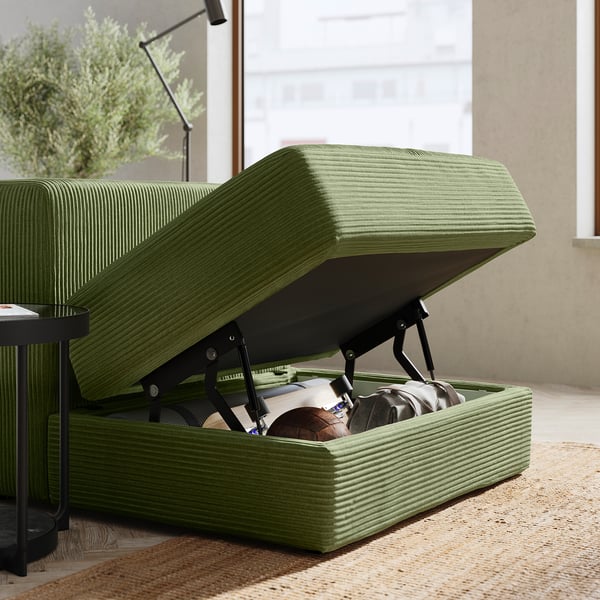 Green JÄTTEBO modular sofa with storage, textured fabric, modern design, open seat revealing stored items, soft cushions, clean lines.