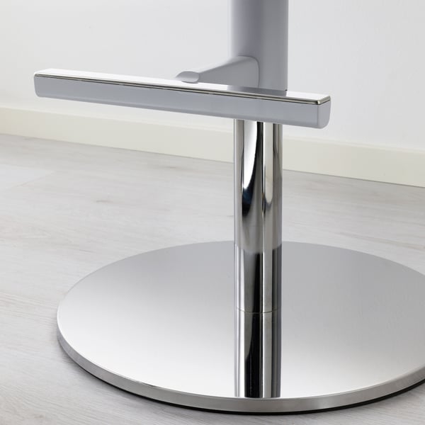 Modern chair base with polished metal stem and circular footrest, showcasing high-quality design and materials.