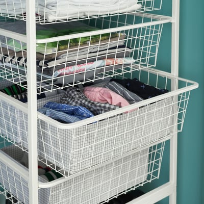 Wire JONAXEL storage unit with shelves holding clothes and accessories, ideal for bedrooms and bathrooms.