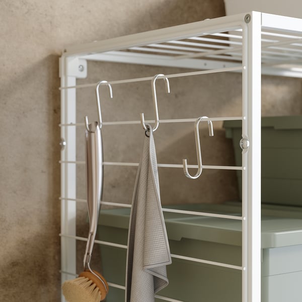 White JOSTEIN storage grid, powder-coated steel, hooks hanging towels, neat bathroom display.