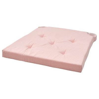 A JUSTINA chair cushion in light pink with a soft, tufted design.