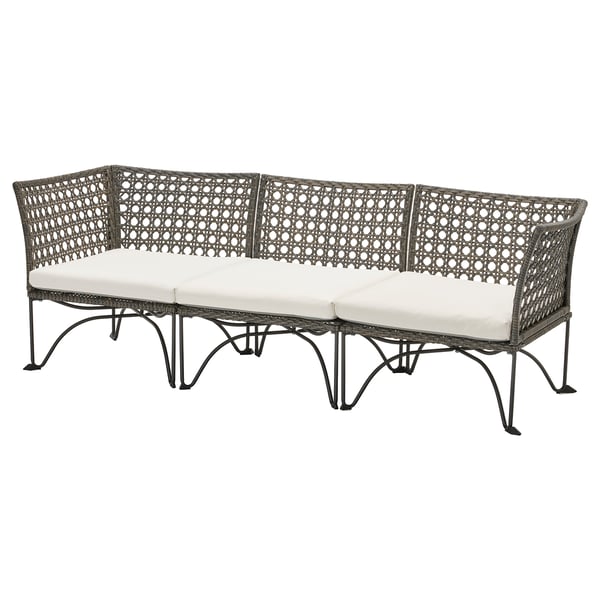 JUTHOLMEN outdoor sofa, gray with white cushions, wicker design, curved shape.