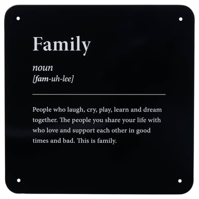 Black metal sign with white text defining family.