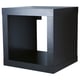 A black ikea KALLAX cube shelving unit. Its square-shaped with open compartments, made from particleboard and fiberboard.