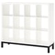 A KALLAX shelving unit in white with a black underframe. It has a modern, square shape with clean lines and multiple open shelves.