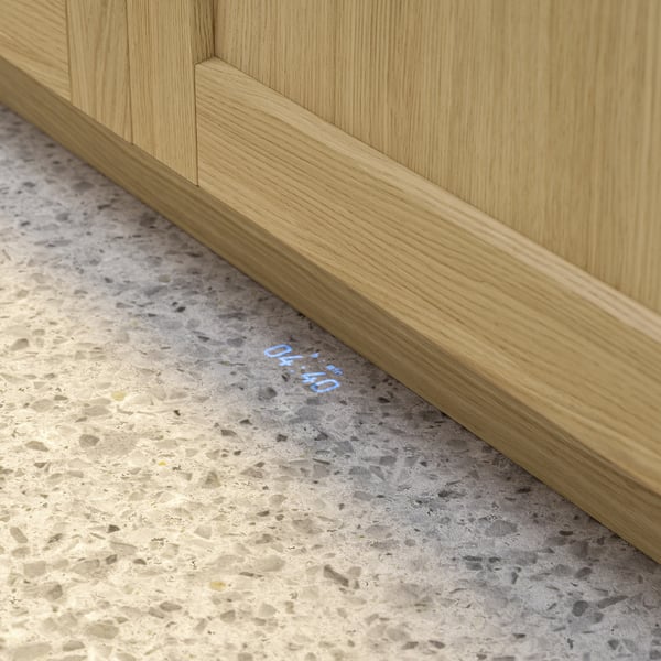 Close-up of dishwashers light beam showing remaining time on floor