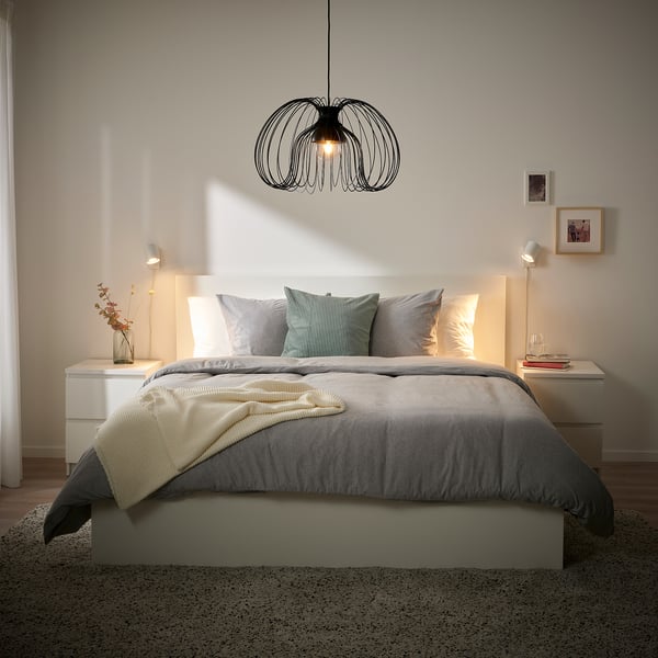 Modern bedroom with grey bed, white linens, and KALLFRONT pendant lamp.
