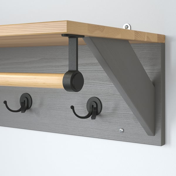 Modern wall-mounted hat rack with wood and metal design, offering three hooks and a shelf.