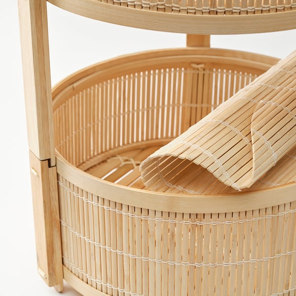 Three-tiered bamboo storage basket, intricately woven, displayed against white background.