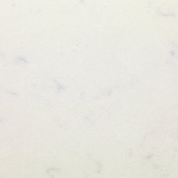 Smooth, light-colored quartz surface with minimal speckles, showcasing high-quality finish suitable for kitchen or bar tops.