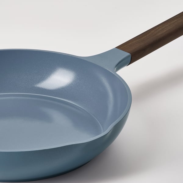Blue non-stick frying pan with wooden handle, showcasing modern design and high-quality construction.