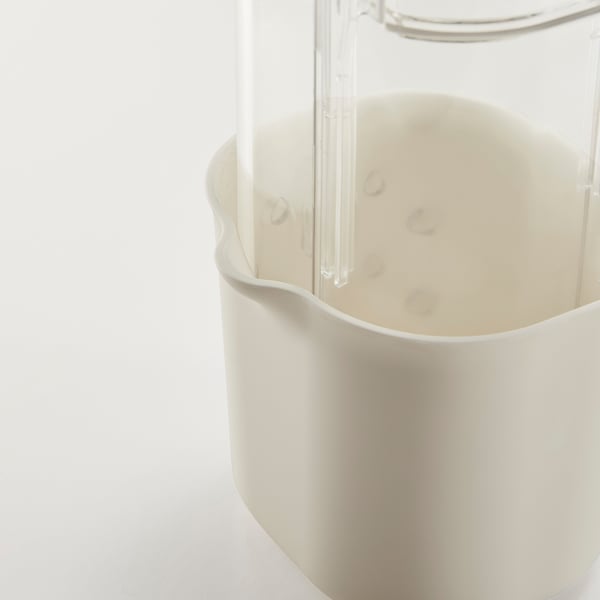 Clear dome-shaped herb keeper with white base, holding water and herbs.