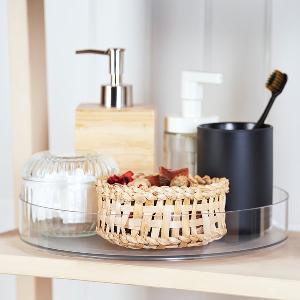 A kitchen countertop organiser with a soap dispenser, toothbrush holder, and decorative basket.