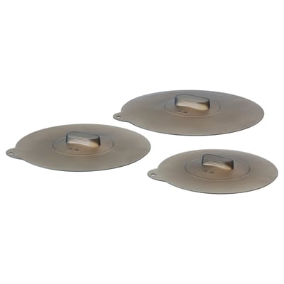 Three round brown silicone lids, each with a small handle, arranged in a triangle.