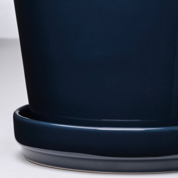 Dark blue planter with matching saucer, sleek design, smooth edges, durable finish.