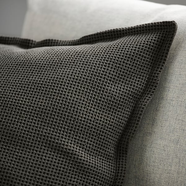 Close-up of premium cushion cover with intricate waffle texture and sleek edge finish.