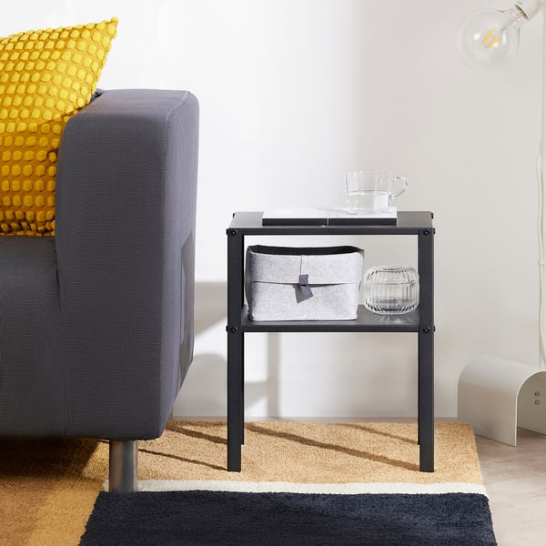 KNARREVIK black bedside table, compact with storage, glass cup, fits small spaces.