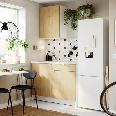 KNOXHULT kitchen: compact, light wood, marble effect, black accents, large window, bright.