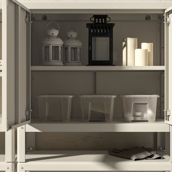 Open storage cabinet showing indoor and outdoor lanterns and plastic bins. Rust-resistant, durable, powder-coated steel.