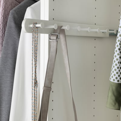White wardrobe organiser with hooks hanging belts and jewellery.