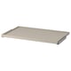 KOMPLEMENT pull-out tray in beige. Rectangular, smooth surface with metallic edges.