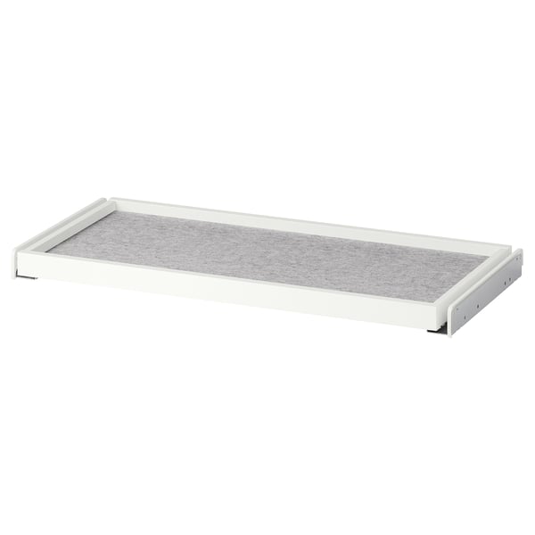 A white KOMPLEMENT pull-out drawer organiser with grey felt lining for wardrobe storage.