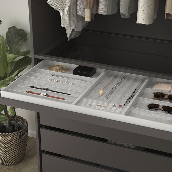 Jewellery organiser tray with compartments for rings, necklaces, and watches, slides out for easy access, protected by soft felt.