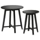 Two black round wooden tables with sleek legs, one larger, one smaller, nested together.
