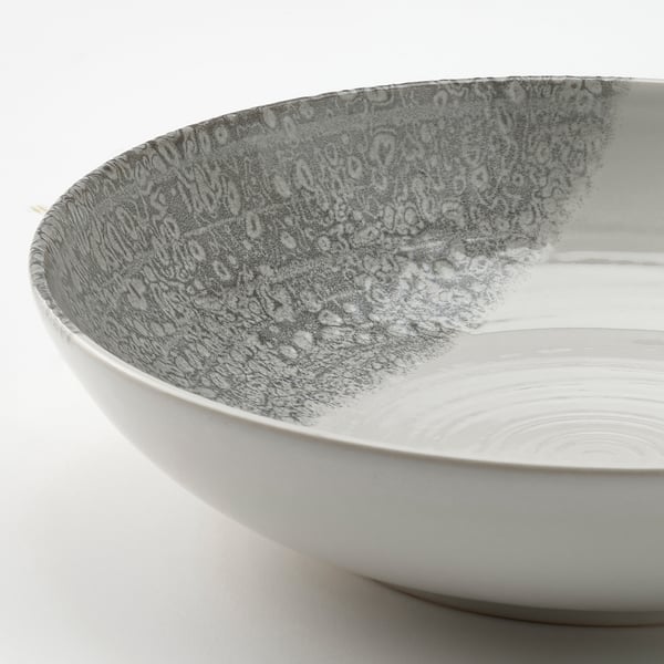 KRUSTISTEL plate with a white base and mottled grey glaze, showcasing a rustic, handcrafted texture.
