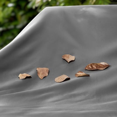 Dark grey waterproof cover with dry leaves, showing quality protection.