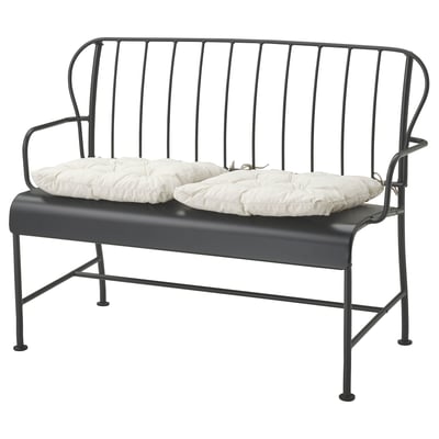 Modern black metal outdoor bench with white cushions, sleek design with curved back and armrests.