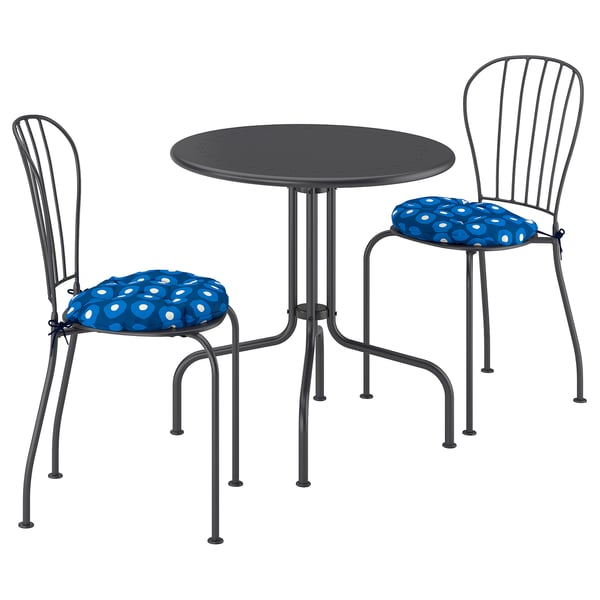Small outdoor table set with two blue dot chairs.