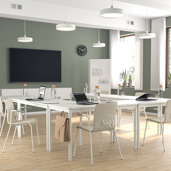Modern conference room with LÄKTARE chairs, laptops, and tv.