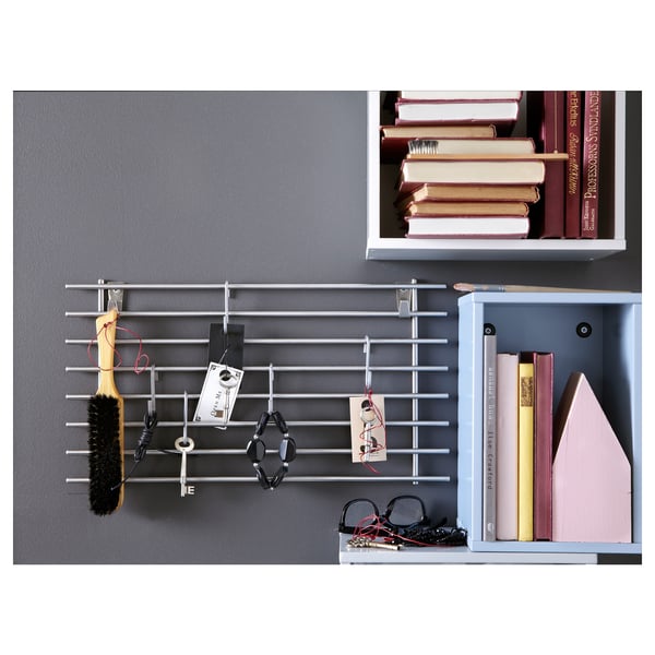Modern wall shelf displaying books, tools, and decor in multiple compartments.